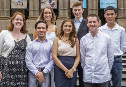 a group of young seven young people standing on stairs outside victorian parliament house