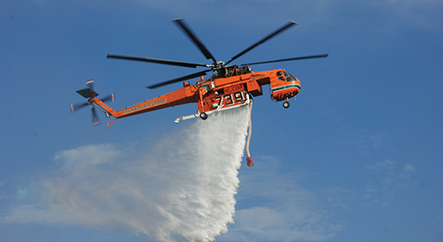 elvis the helicopter dropping water on a bushfire