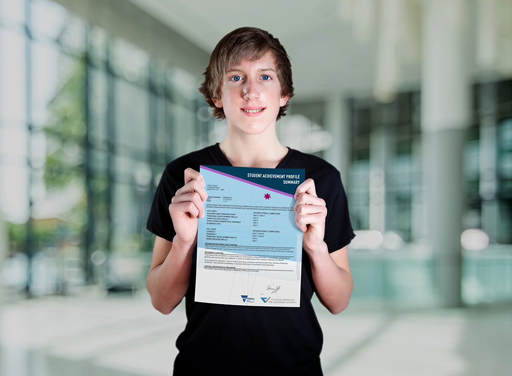 A boy holding the Student Achievement Profile