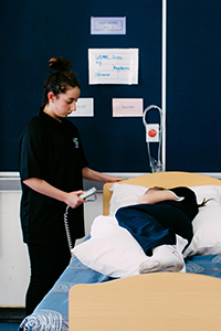 A Health student looking after a patient
