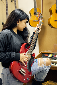 A female student playing a guitar